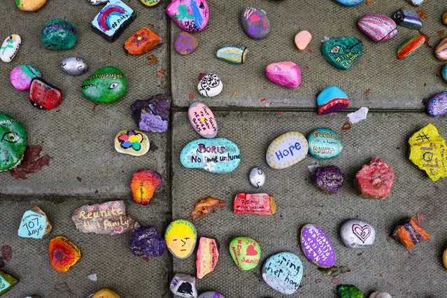 Stones with messages painted by children next to Richard Ratcliffe (not pictured) outside the Foreign Office in London, Britain, 26 October 2021. Richard Ratcliffe, the husband of Nazanin Zaghari-Ratcliffe has gone on hunger strike for the second time in two years and intends to sleep in a tent after his wife lost her latest appeal in Iran. (Photo by Vickie Flores/EPA/EFE)