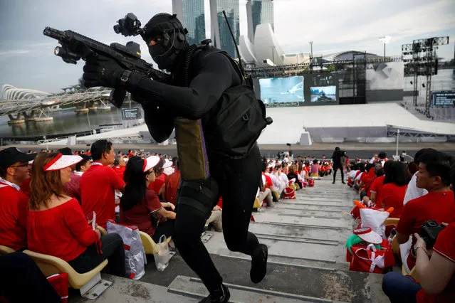 A navy diver storms into the gallery during a military display at Singapore's 52nd National Day celebrations at Marina Bay in Singapore August 9, 2017. (Photo by Edgar Su/Reuters)