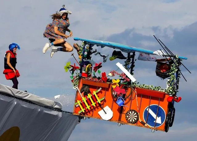 A makeshift aircraft plummets into the Moskva River during the Red Bull Flugtag Moscow 2011 competition. (Photo by Mikhail Metzel/Associated Press)