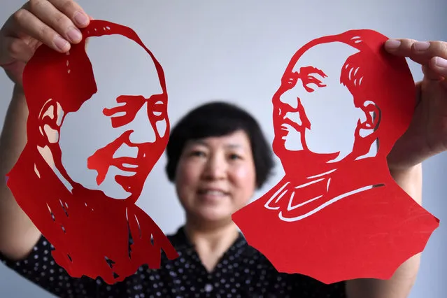 A local artist presents a Chinese paper-cut of Chairman Mao which she made to celebrate the 95th anniversary of the foundation of Communist Party of China in Handan, Hebei Province, China, June 30, 2016. (Photo by Reuters/China Daily)