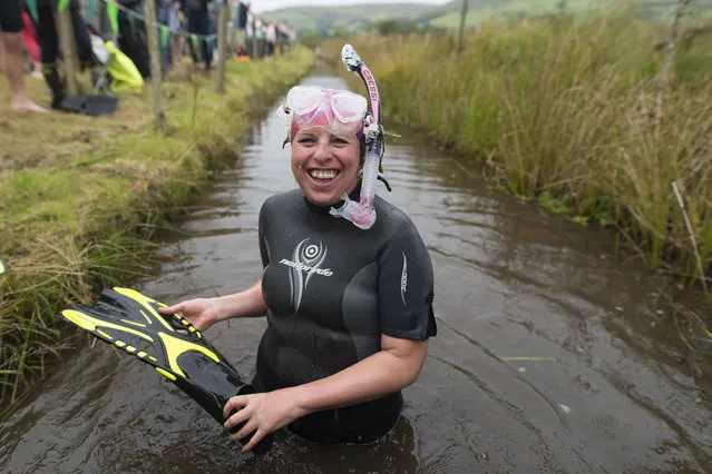 A woman prepares to swim during the World Bog Snorkelling Championships 2017 on August 27, 2017 in Llanwrtyd Wells, Wales. (Photo by Matthew Horwood/Getty Images)