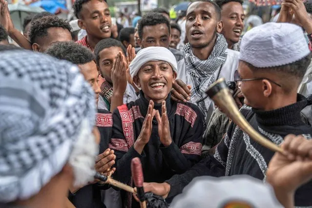 Muslim worshippers sing songs during the Eid al-Adha prayers on the first day of the feast celebrated by Muslims worldwide, at the outskirts of a soccer stadium in Addis Ababa, Ethiopia, on July 9, 2022. (Photo by Amanuel Sileshi/AFP Photo)