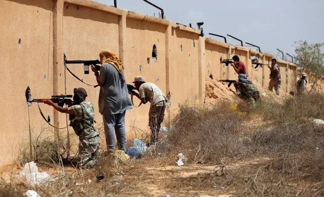 Libyan forces allied with the U.N.-backed government fire weapons at Islamic State fighters in Sirte, Libya, July 15, 2016. (Photo by Goran Tomasevic/Reuters)