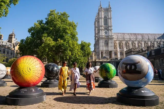 (L-R) Selina Jones, Exhibition Artistic Director Lady Ashley Shaw Scott Adjaye and exhibition founder Michelle Gayle views globe sculptures from “The World Reimagined”, at Dean's Yard at Westminster Abbey, London on Thursday, August 11, 2022, ahead of the launch of a new public art trail. The World Reimagined is launching the UK's largest public art trail across seven cities, including London, during which more than 100 artists will unveil globe sculptures reflecting upon colonial histories and the impact of the slave trade on our histories. (Photo by Dominic Lipinski/PA Images via Getty Images)
