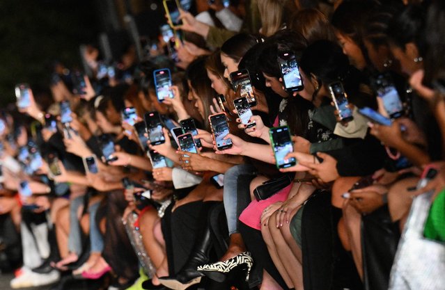 Guests hold their smartphones to record the Boohoo by Kourtney Kardashian show during New York Fashion Week on September 13, 2022 in New York city. (Photo by Angela Weiss/AFP Photo)