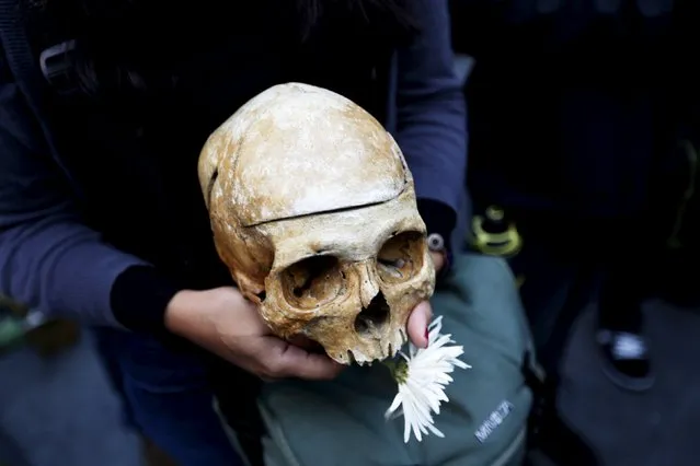 A protester holds a skull during a protest against what protesters say is the death of Guatemalan democracy in Guatemala City, September 5, 2015. Guatemala on Sunday will hold a presidential election. (Photo by Jorge Dan Lopez/Reuters)