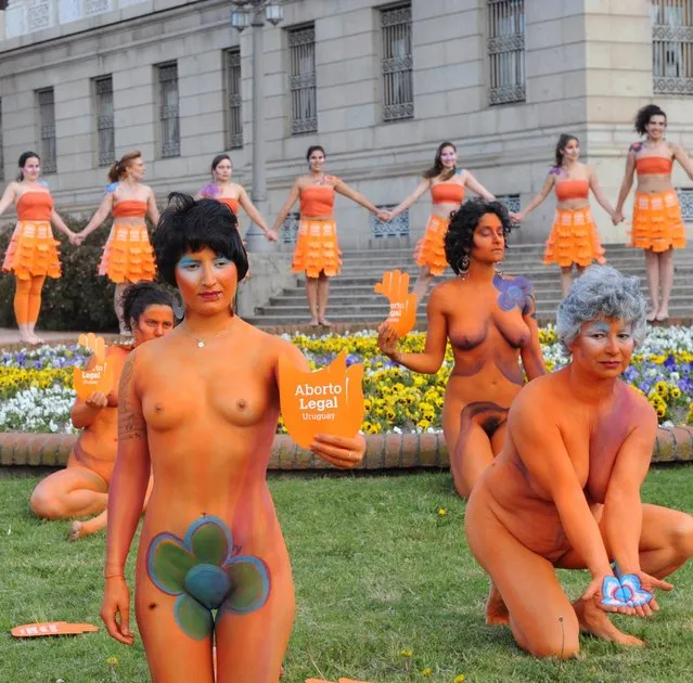 Women with body paintings and signs reading "Legal abortion", take part in a demo in favour of the legalization of abortion in front of the Congress building in Montevideo on September 25, 2012. The Congress is voting a law project which would decriminilize the interruption of pregnancy under certain conditions, including obliging women to set out before a tribunal the reasons for the abortion.  AFP PHOTO/Miguel ROJO        (Photo credit should read MIGUEL ROJO/AFP/GettyImages)