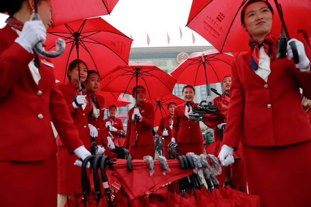 Ushers manage umbrellas used by delegates arriving for the opening session of the 19th National Congress of the Communist Party of China at the Great Hall of the People in Beijing, China on October 18, 2017. (Photo by Damir Sagolj/Reuters)