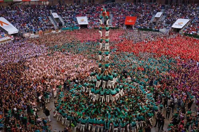 Castellers de Vilafranca form a human tower called “castell” during a biannual human tower competition in Tarragona, Spain on October 2, 2022. (Photo by Albert Gea/Reuters)