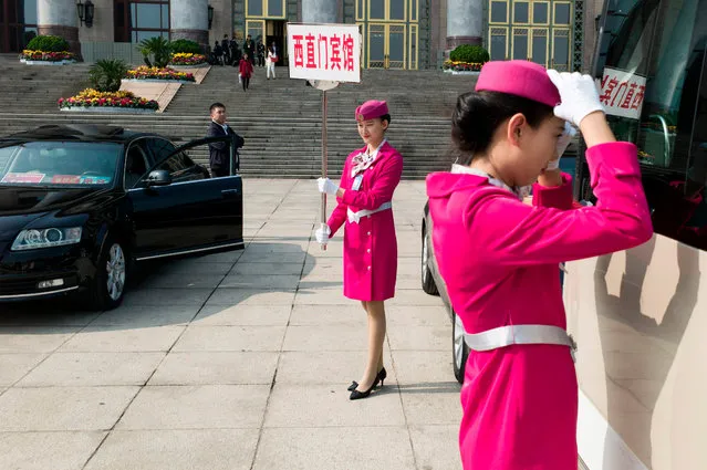 Hostesses wait for delegates in front of the Great Hall of the People during the Communist Party' s 19 th Congress in Beijing on October 19, 2017. The Chinese Communist Party opens its week- long, twice- a-decade congress on October 18 at the Great Hall of the People. (Photo by Fred Dufour/AFP Photo)