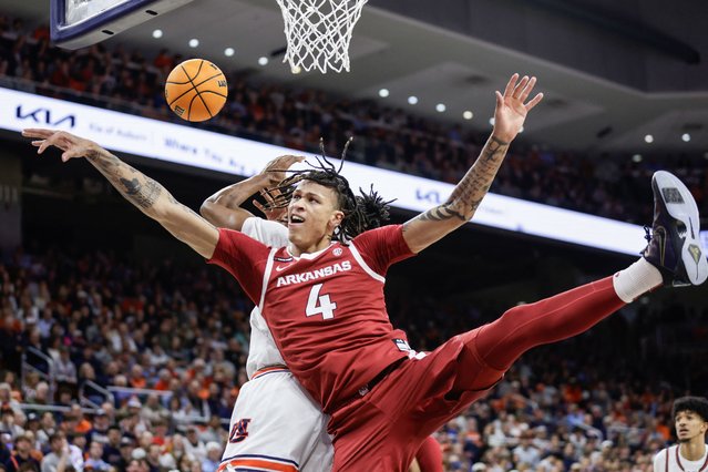 Trevon Brazile #4 of the Arkansas Razorbacks and Chaney Johnson #31 of the Auburn Tigers battle for a rebound during the first half at Neville Arena on February 19, 2025 in Auburn, Alabama. (Photo by Stew Milne/Getty Images/AFP Photo)