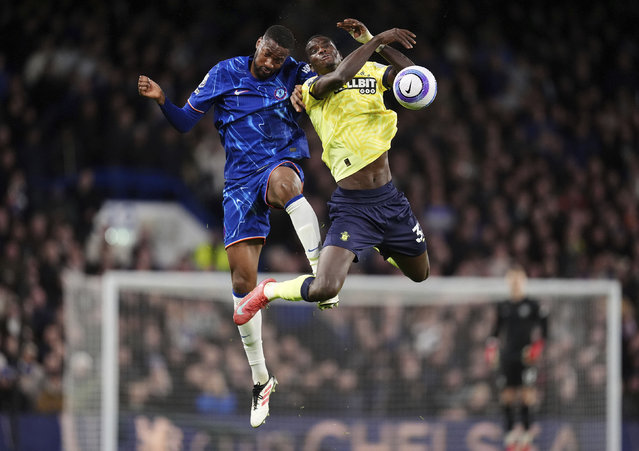 Chelsea's Tosin Adarabioyo, left, and Southampton's Paul Onuachu battle for the ball during the English Premier League soccer match at Stamford Bridge, London, Tuesday, February 25, 2025. (Photo by John Walton/PA Wire via AP Photo)