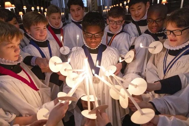 Choristers light their candles during a photocall at St Paul's Cathedral on December 21, 2021 in London, England. The Choristers of St Paul's have a busy programme of Advent and Christmas services, performing favourites like “Hark the Herald Angels Sing” and “Once In Royal David's city”. (Photo by Dan Kitwood/Getty Images)
