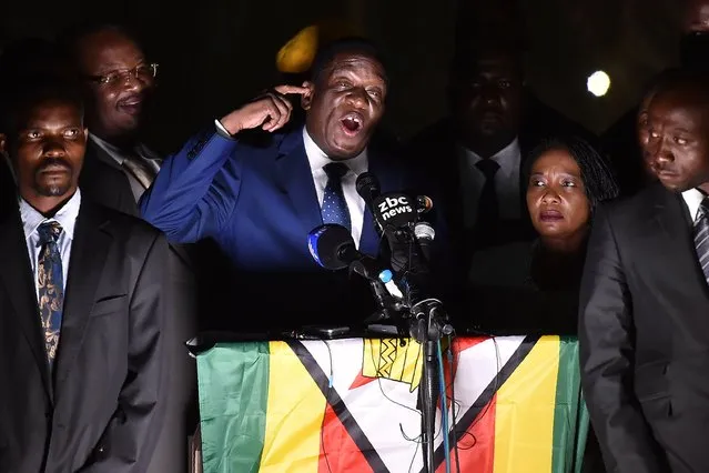 Zimbabwe' s incoming president Emmerson Mnangagwa (3rd L) speaks to supporters flanked by his wife Auxilia (2nd R) surrounded by their bodyguards at Zimbabwe' s ruling Zanu- PF party headquarters in Harare on November 22, 2017. Zimbabwe' s former vice president Emmerson Mnangagwa flew home on November 22 to take power after the resignation of Robert Mugabe put an end to 37 years of authoritarian rule. Mnangagwa will be sworn in as president at an inauguration ceremony on November 24, officials said. (Photo by Tony Karumba/AFP Photo)