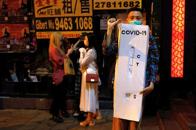 A man wears a costume celebrating Halloween in front of a closed bar at Lan Kwai Fong in Hong Kong, China on October 31, 2022. (Photo by Tyrone Siu/Reuters)