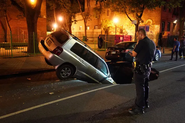 A car that fell into a large sinkhole which opened up on E2nd Street near Avenue A in New York, NY around 1:15 a.m. on June 28, 2020. (Photo by Christopher Sadowski/The New York Post)