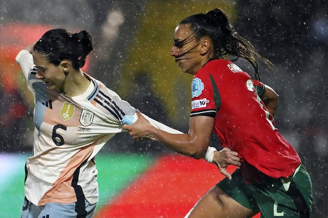 Portugal's defender #02 Catarina Amado (R) fights for the ball with Spain's midfielder #06 Aitana Bonmati during the UEFA Women's Nations League group A3 football match between Portugal and Spain in Capital do Movel stadium, Pacos de Ferreira on April 4, 2025. (Photo by Miguel Riopa/AFP Photo)