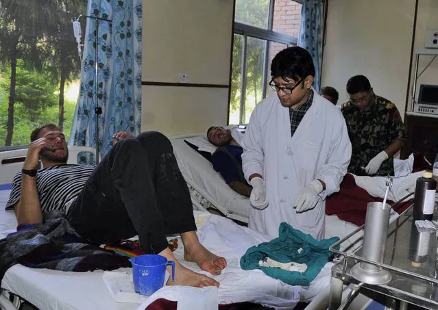 In this Thursday, October 16, 2014 photo released by Nepalese Army, unidentified survivors of an avalanche are treated at Army Hospital in Katmandu, Nepal. Rescuers widened their search Friday for trekkers stranded since a series of blizzards and avalanches battered the Himalayas in northern Nepal early this week leaving at least 29 people killed, officials said. (Photo by AP Photo/Nepalese Army)