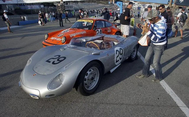 A visitor takes a photo during the "Concours of Pit Lane" at the Porsche Rennsport Reunion V at Laguna Seca Raceway near Salinas, California, September 26, 2015. (Photo by Michael Fiala/Reuters)