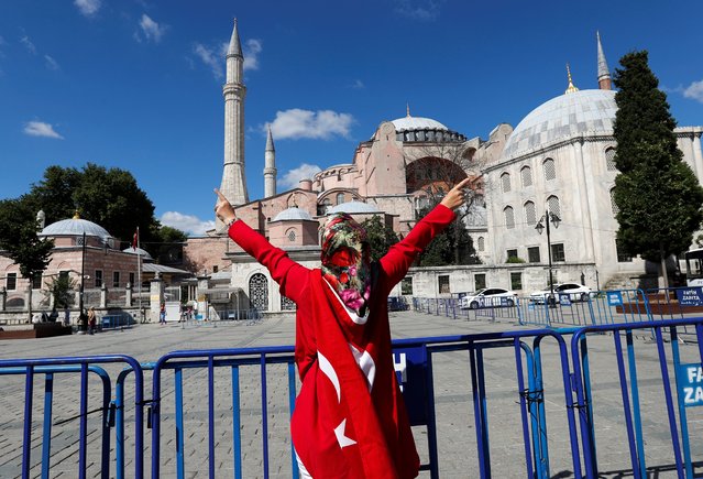 A woman gestures in front of the Hagia Sophia or Ayasofya, after a court decision that paves the way for it to be converted from a museum back into a mosque, in Istanbul, Turkey, July 10, 2020. (Photo by Murad Sezer/Reuters)