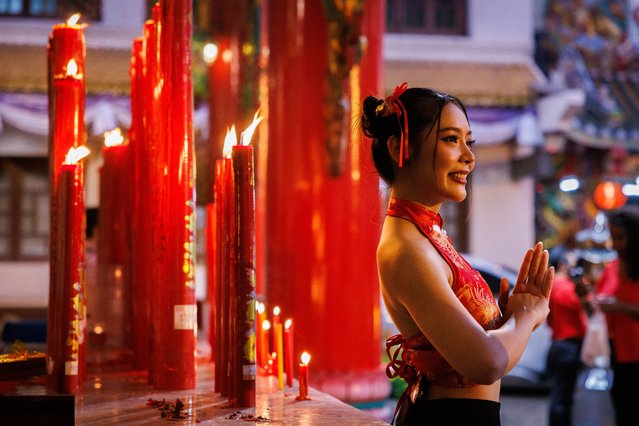 People light candles at Kuan Yim Shrine in Chinatown on Lunar New Years Eve on February 09, 2024 in Bangkok, Thailand. The Chinese diaspora of Southeast Asia celebrates a lively Lunar New Year in Bangkok's Chinatown. It is traditionally a time for people to meet their relatives and take part in celebrations with families. In Thailand, which has a sizeable population of Chinese lineage, people gather with family and celebrate with feasts and visits to temples. The Tourism Authority of Thailand is expecting a steep increase in tourism during the Lunar New Year now that visa free travel is permmited for Chinese citizens to Thailand. (Photo by Lauren DeCicca/Getty Images)