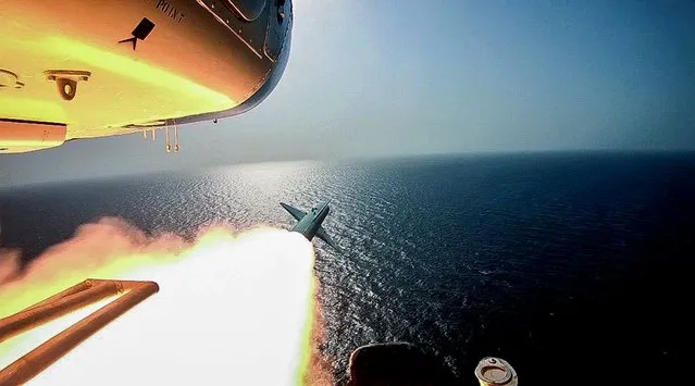 In this photo released Tuesday, July 28, 2020, by Sepahnews, Revolutionary Guard's helicopter fires a missile during an exercise. Iran's paramilitary Revolutionary Guard fired a missile from a helicopter targeting a replica aircraft carrier in the strategic Strait of Hormuz, state television reported on Tuesday, an exercise aimed at threatening the U.S. amid tensions between Tehran and Washington. (Photo by Sepahnews via AP Photo)