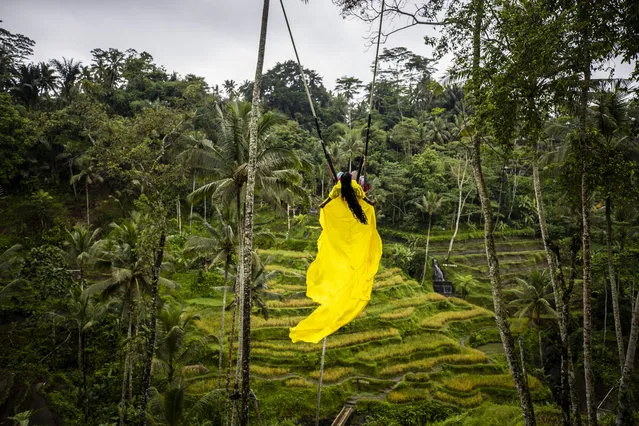 A woman swings in the forest as there are places for hiking, yoga and spa centers in Bali, Indonesia on November 13, 2022. Many tourists visit Bali, which is one of the millions island in Indonesia, every season of the whole year. (Photo by Emin Sansar/Anadolu Agency via Getty Images)