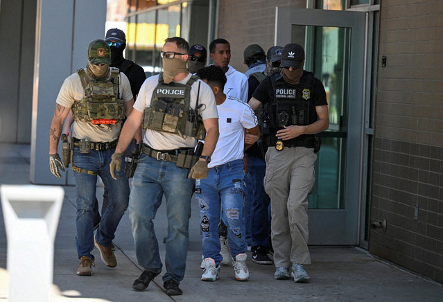 Law enforcement officers, including HSI and ICE agents, take people into custody at an immigration court in Phoenix, Arizona on May 21, 2025. (Photo by Caitlin O'Hara/Reuters)