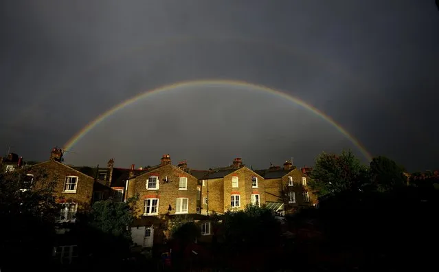 A double rainbow is seen above a row of terrace houses in Clapham, south London, Britain September 1, 2015. The second rainbow, above the main arc has the sequence of its colours reversed, with red on the inner side of the bow. (Photo by Dylan Martinez/Reuters)