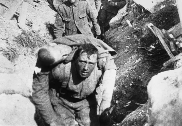 The Battle Of The Somme, Still from the British film “The Battle of the Somme”. The image is part of a sequence introduced by a caption reading “British Tommies rescuing a comrade under shell fire. (This man died 30 minutes after reaching the trenches)”.The scene is generally accepted as having been filmed on the first day of the Battle of the Somme, 1 July 1916. This image, and the film sequence from which it is derived, has been widely published to evoke the experience of trench warfare, the heroism and suffering of the ordinary soldier, and the huge casualties sustained by the British Army during the initial assault on German lines. In spite of considerable research, the identity of the rescuer remains unconfirmed. The casualty appears to be wearing the shoulder flash of 29th Division, 1 July 1916. (Photo by Geoffrey Malins/IWM via Getty Images)