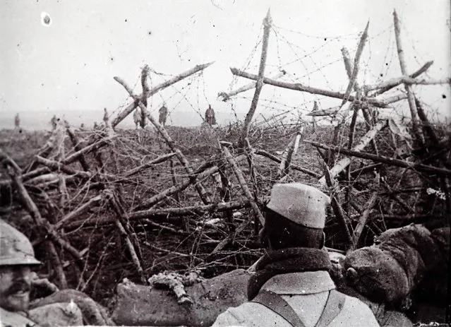 German soldiers (rear) offer to surrender to French troops, as seen from a listening post in a trench at Massiges, northeastern France, in this undated archive picture. (Photo by Denise Follveider/Reuters/Collection Odette Carrez)