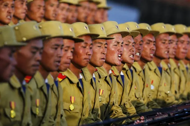 Soldiers shout slogans as they march past a stand with North Korean leader Kim Jong Un during the parade celebrating the 70th anniversary of the founding of the ruling Workers' Party of Korea, in Pyongyang October 10, 2015. (Photo by Damir Sagolj/Reuters)