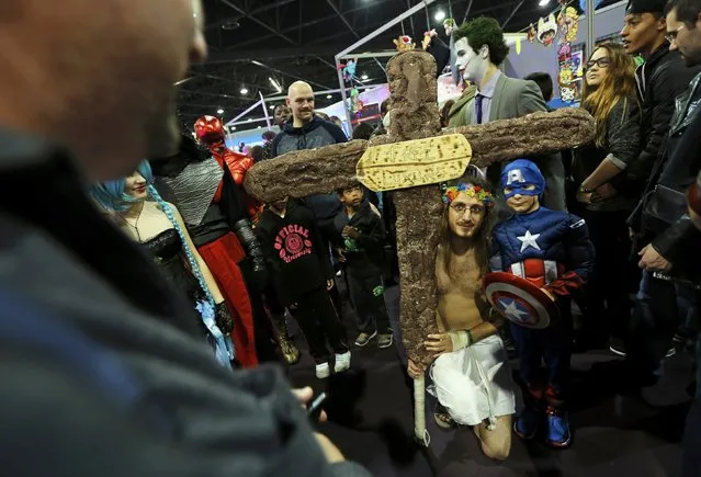 A participant dressed as Jesus Christ poses for a picture besides a young boy wearing a superhero Captain America costume during the first edition of the HeroFestival in Marseille, November 9, 2014. (Photo by Jean-Paul Pelissier/Reuters)