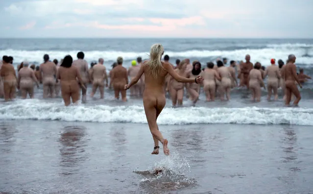 Participants in the annual North East Skinny Dip run into the sea at Druridge Bay, Britain, September 25, 2016. About 500 people swam naked in the North Sea in aid of charity. (Photo by Russell Cheyne/Reuters)