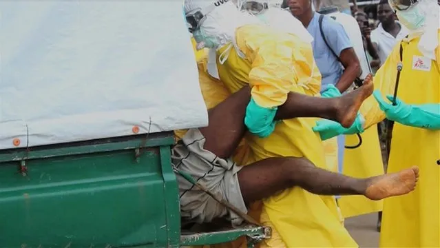 Health workers push an Ebola patient who escaped from quarantine at Monrovia's ELWA Hospital, into an ambulance in the centre of Paynesville, in this file still image taken from a September 1, 2014 video. (Photo by Reuters/Reuters TV)