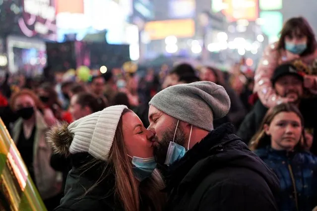 People kiss during the New Year's celebrations in Times Square, as the Omicron coronavirus variant continues to spread, in the Manhattan borough of New York City, U.S., January 1, 2022. (Photo by Dieu-Nalio Chery/Reuters)