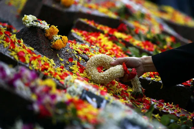 A woman lays a garland on a memorial during the 40th anniversary of a campus massacre by state forces in the military-ruled country at Thammasart University in Bangkok, Thailand. October 6, 2016. (Photo by Athit Perawongmetha/Reuters)