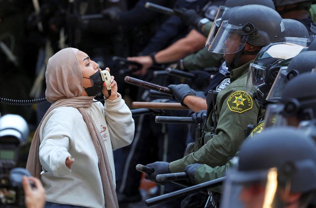 Demonstrators face off with law enforcement officers deployed to the University of California, Irvine (UC Irvine), after protesters against the war in Gaza surrounded the physical sciences lecture hall, as the conflict between Israel and the Palestinian Islamist group Hamas continues, in Irvine, California, U.S. May 15, 2024. (Photo by Mike Blake/Reuters)
