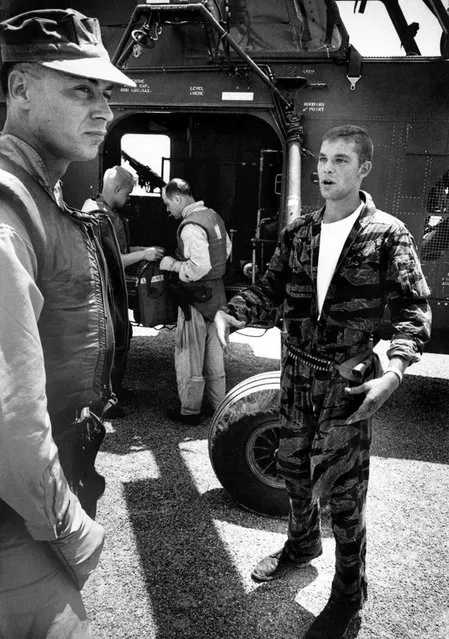Farley talks to his own pilot, Captain Vogel, about the pilot who had to be left behind in YP3. “If we had stayed another 10 seconds under those V.C. machine guns”, Vogel said, “you or us would never have got out of there”. (Photo by Larry Burrows/Time & Life Pictures)