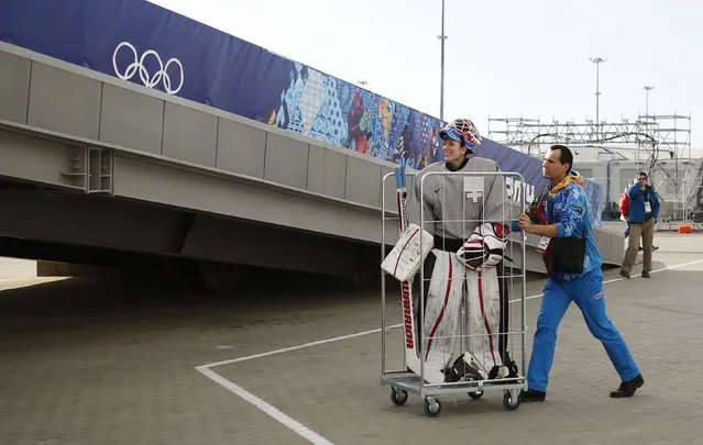 A volunteer pushes Switzerland's goaltender Sophie Anthamatten in a trolley as she leaves the Shayba Arena following a practice session ahead of the 2014 Sochi Winter Olympics, in this February 6, 2014 file photo. (Photo by Phil Noble/Reuters)