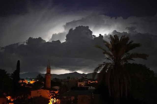 Black clouds cover the sky during a storm above the landmark Suleimiye (Selimiye) mosque – a former Roman Catholic cathedral turned into a mosque during the Ottoman rule of Cyprus – in the Turkish-controlled northern part of Nicosia, the divided capital of the east Mediterranean island early on November 10, 2022. (Photo by Roy Issa/AFP Photo)