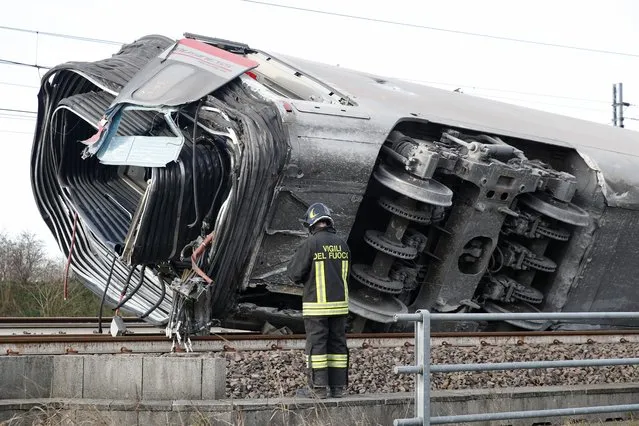 A firefighter inspects a derailed train carriage, near Lodi, northern Italy, Thursday, February 6, 2020. Italian authorities say a high-speed passenger train has derailed in northern Italy, killing two railway workers and injuring 27 people. (Photo by Antonio Calanni/AP Photo)