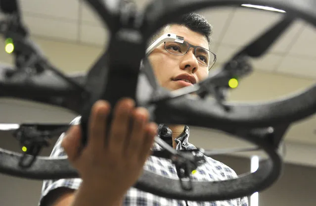 In this October 8, 2014 photo, undergraduate researcher Christopher Rios uses Google Glass to control a drone in mechanical engineering professor Ahmed Mahdy's classroom at Texas A&M Corpus Christi, in Corpus Christi, Texas. (Photo by Pat Sullivan/AP Photo)