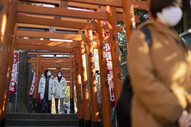 Worshippers visit shrines situated side by side in Tokyo on New Year's Day, Friday, January 1, 2021. (Photo by Hiro Komae/AP Photo)