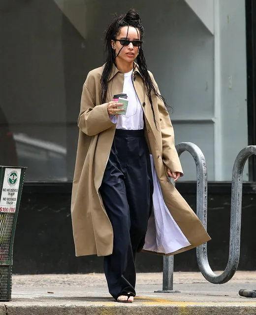 Zoë Kravitz is spotted on a coffee run with a friend in New York City on April 24, 2023. The American actress wore a tan trench coat, white blouse, black trousers, and matching sandals. (Photo by The Image Direct)