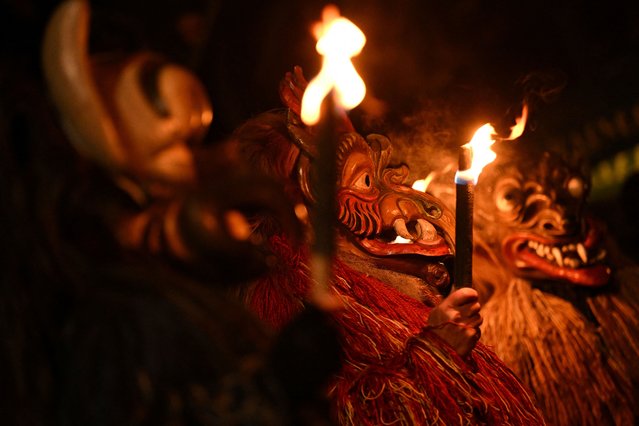 People dressed in fur, animal costumes, and masks participated in the traditional Perchten parade in Frauenneuharting, near Munich, Germany on December 4, 2024. (Photo by Angelika Warmuth/Reuters)