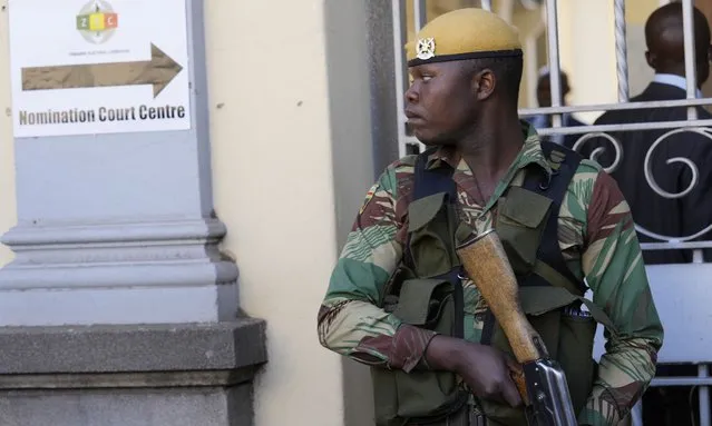 An armed soldier stands guard outside the nomination court in Harare, Zimbabwe, Wednesday, June 21, 2023. Zimbabwean President President Emmerson Mnangagwa visited the nomination court where his chief election agent filed papers registering him as a candidate for the national elections that would be held on Aug. 23. (Photo by Tsvangirayi Mukwazhi/AP Photo)