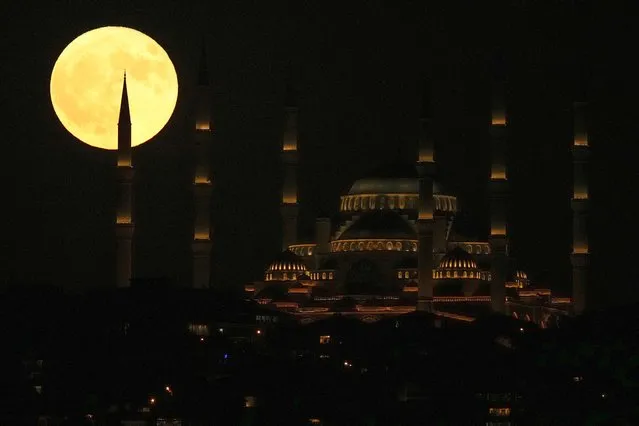 A super moon rises behind Camlica mosque in Istanbul, Turkey, Monday, July 3, 2023. (Photo by Francisco Seco/AP Photo)