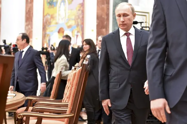 Russia's President Vladimir Putin takes part in peace talks on resolving the Ukrainian crisis, with his French counterpart Francois Hollande seen in the background, in Minsk, February 11, 2015. (Photo by Kirill Kudryavtsev/Reuters)