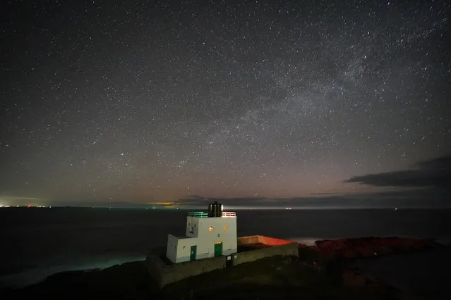 The Milky Way core rises at 3.00am over Bamburgh Lighthouse in Northumberland on the North East coast of England on Thursday, March 23, 2023. (Photo by Owen Humphreys/PA Images via Getty Images)